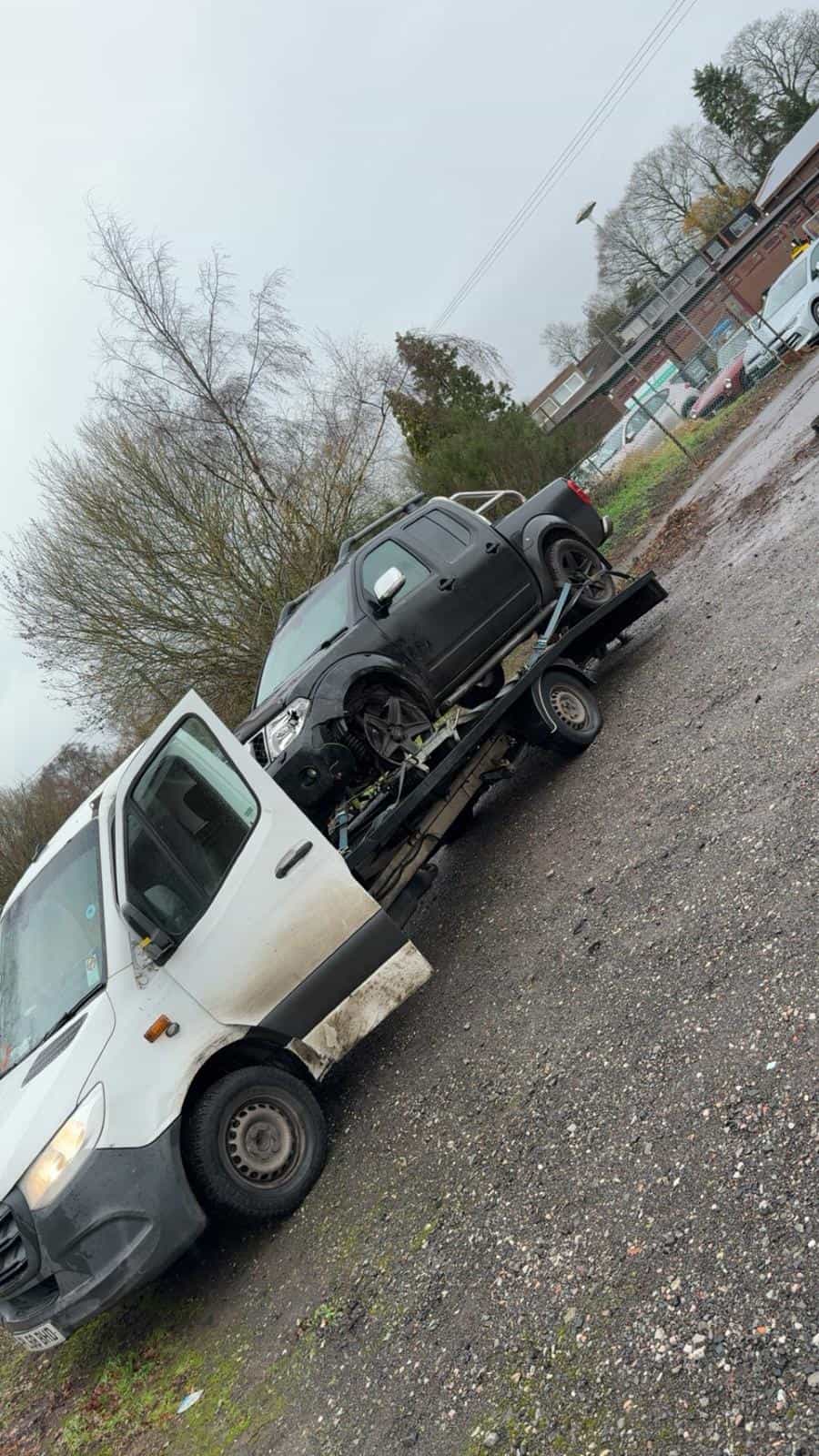 Flatbed tow truck transporting a black car in Telford & Wrekin.