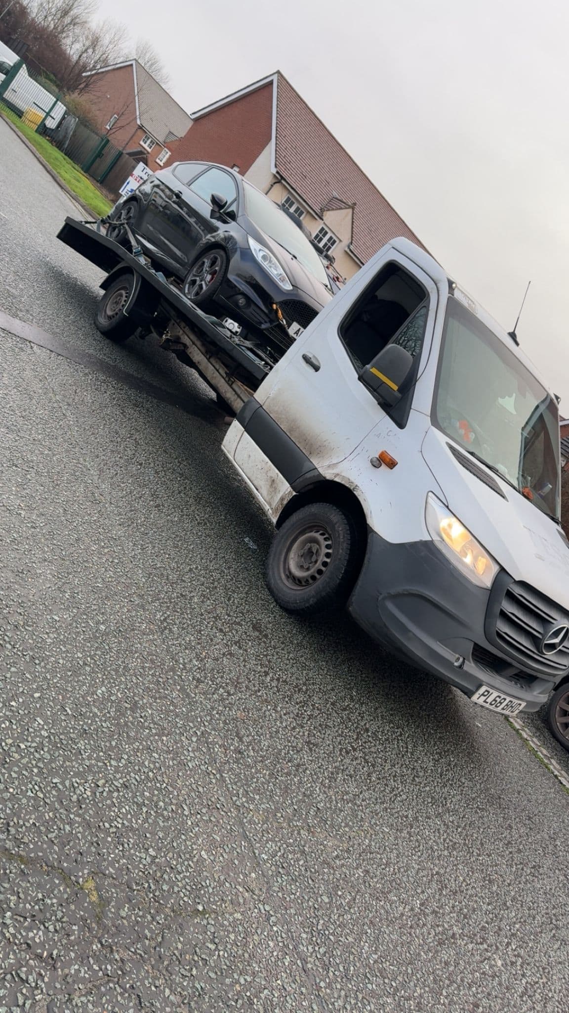 Recovery truck transporting a damaged car in Telford.